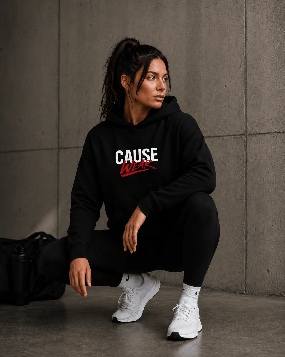 Black hoodie with hood, front CAUSE WEAR logo, kangaroo pocket.
